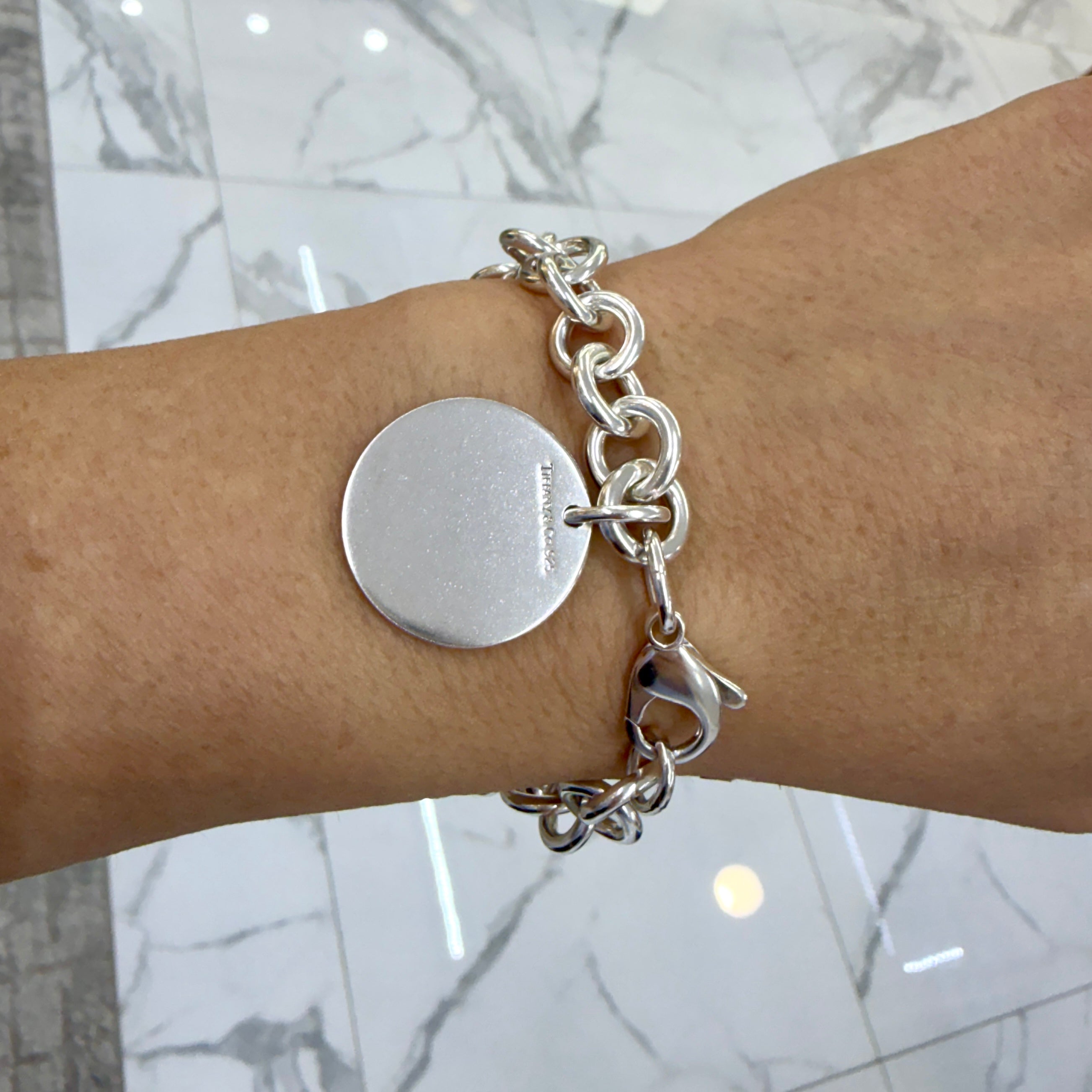 Ladies Tiffany & Co. 925 Sterling Silver Round Tag Charm Rolo Link Bracelet